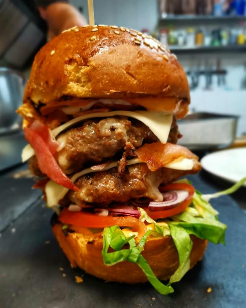 The DOUBLE-DECKER   Double 100% Beef Patty | Double Bacon | Double Cheese | Lettuce | Tomato | Onion | Pickle | Burger Sauce
