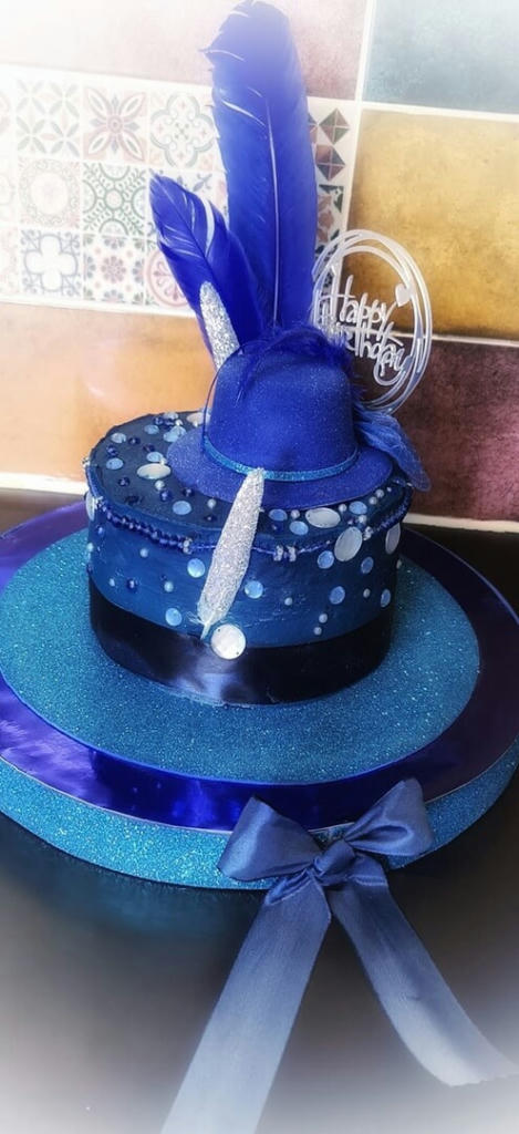 A vanilla sponge filled with homemade salted caramel and salted caramel buttercream. The decoration again salted caramel but dyed blue, loads of sparkles and royal blue accessories.