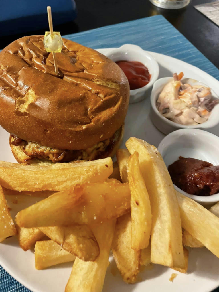 Roof terrace burger with bacon, cheese, hand cut chips and coleslaw - September 2023