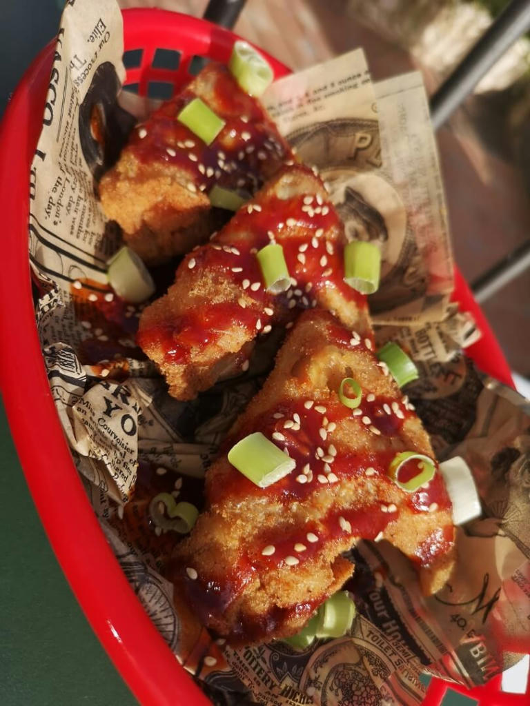 Chicken wings, drizzled with homemade Korean sauce and topped with spring onions and sesame seeds - July 2023