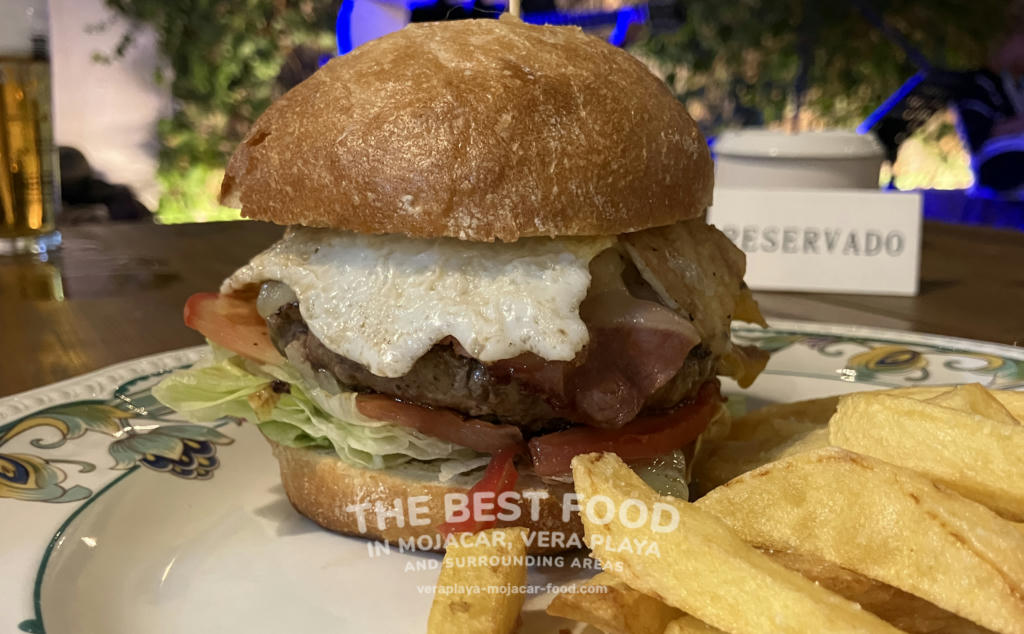 Burger with cheese, lettuce, onion, tomato, fried egg and bacon - August 2024