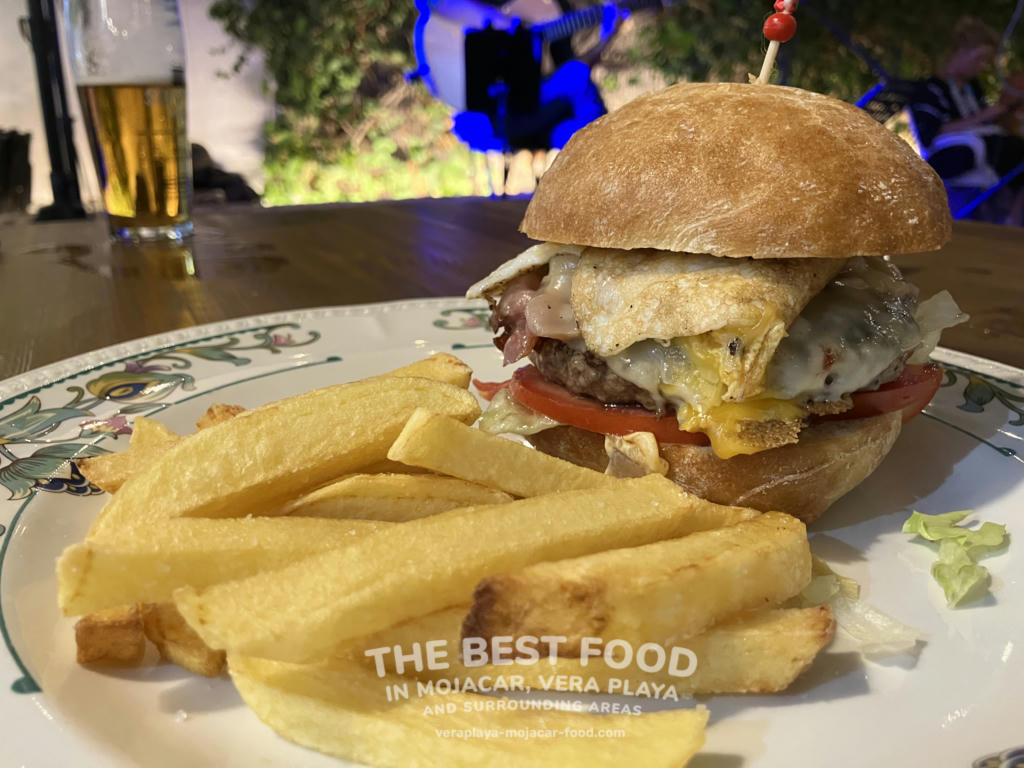 Burger with cheese, lettuce, onion, tomato, fried egg and bacon - August 2024