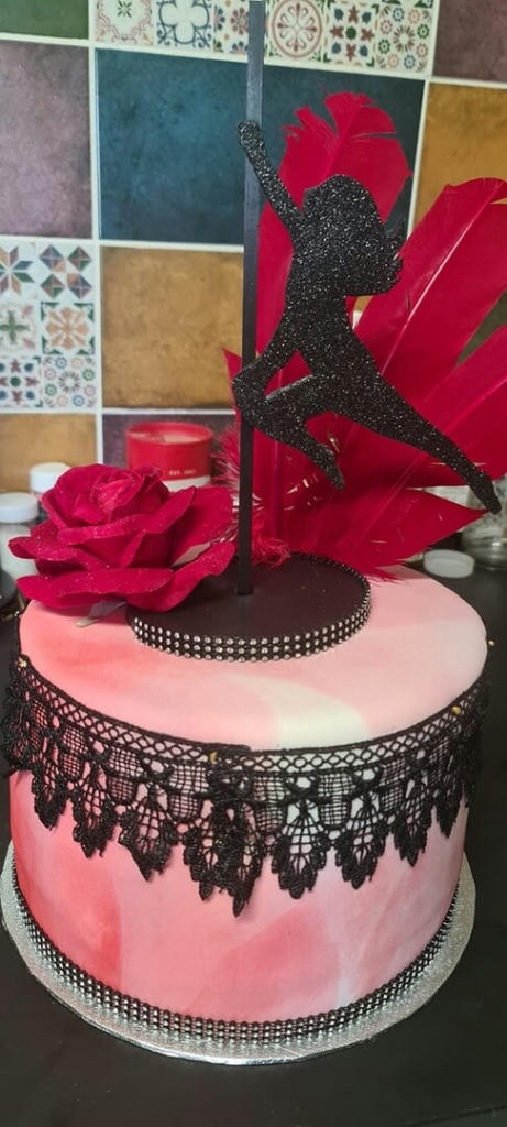 A huge cake of 4 layers of vanilla sponge, homemade jam and vanilla buttercream. Covered in a marbled fondant decorated with a bit of bling, lace and of course the pole dancer. 