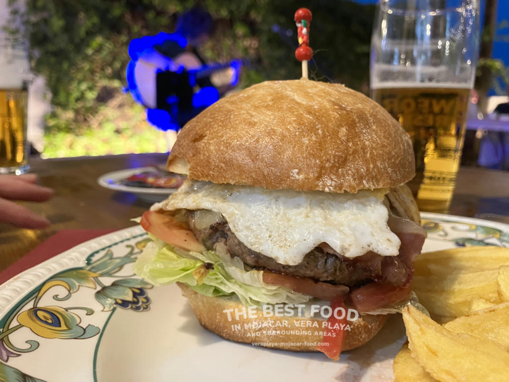 Burger with cheese, lettuce, onion, tomato, fried egg and bacon - August 2024