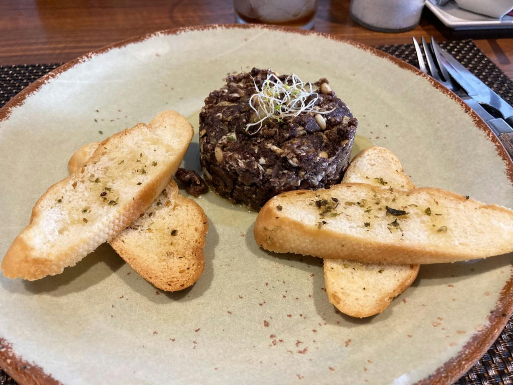 Scrambled egg with black pudding and pine nuts